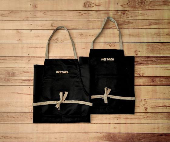 Black bib aprons with beige straps and ties, pair, custom made by RestroCart, New Delhi