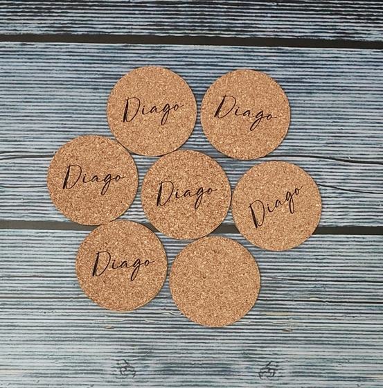 Cork coasters with black script logo arranged in a flower shape, custom made by RestroCart, New Delhi