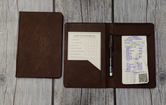 Brown leatherette bill folders with embossed logo, pen and receipt, custom made by RestroCart, New Delhi